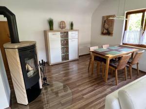 a living room with a wood stove and a table at Albbruck, Feriendomizil Albsteig in Albbruck +6 photos