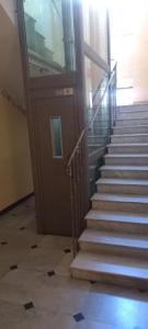 a set of stairs in a building with a door at Corso Garibaldi mansarda in Sanremo