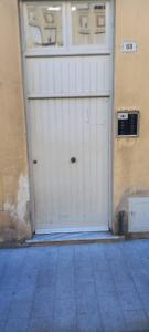 a white garage door in a building at Corso Garibaldi mansarda in Sanremo