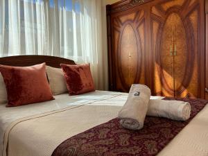 a hotel room with a bed with a rolled up towel at Luxury Villa, 3 Levels, 5 bedrooms, 5 Baths, Pool & Garden in Tétouan +42 photos