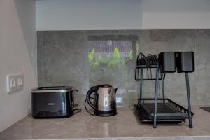 a kitchen with a coffee maker and a toaster at Ratih Guest House in Ubud