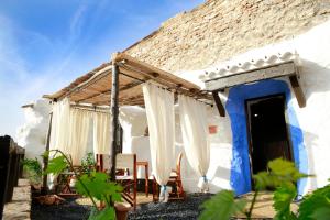 a white and blue house with awning at Balcones de Piedad in Los Balcones