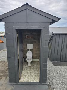 a bathroom with a toilet in a building at Howsthaserenitee - 3BR house with bay views in Coffin Bay +11 photos