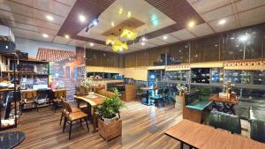 a restaurant with tables and chairs in a room at Mi Lan Boutique Resort in Vung Tau