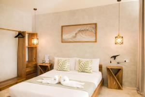 two towels on a bed in a room at Moringa Private Room in General Luna