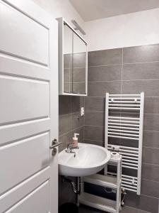 a bathroom with a sink and a mirror at District B Apartments in Brno