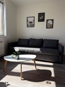 a living room with a couch and a coffee table at District B Apartments in Brno