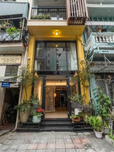 a building with potted plants in front of it at An Yên Island - Art Boutique Stay with Dual Lake view in Hanoi