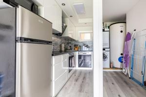 a kitchen with a stainless steel refrigerator at Immensee Appartments by Mainka Properties in Immensee