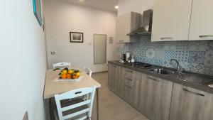 a kitchen with a sink and a counter with oranges on it at Casa Michela in Sant'Agnello
