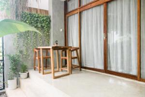 a room with a table and a glass door at Moringa Private Room in General Luna