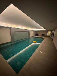 a swimming pool with a yellow frisbee in it at Pinnacle Row Panoramic 2BR Oasis in Muscat