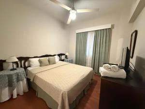 a bedroom with a bed and a flat screen tv at Gran Hotel Mar del Plata in Mar del Plata