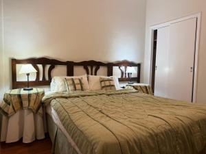 a bedroom with a large bed and two tables with lamps at Gran Hotel Mar del Plata in Mar del Plata +26 photos