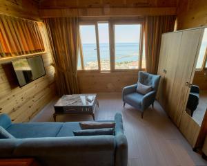 a living room with a couch and two chairs and a table at Sarı Köşk Hotel in Rize +13 photos