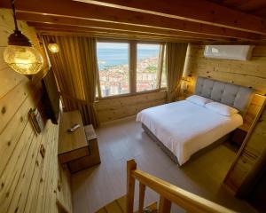 a bedroom with a bed and a large window at Sarı Köşk Hotel in Rize