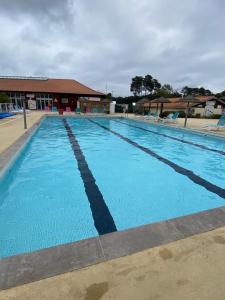 a large swimming pool with blue water at Mobilhome 592 FUNPASS NON INCLUS in Gastes