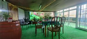 a dining room with a table and chairs in a room at Hospedaje Villa Blas in Redondela