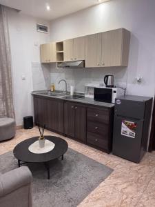 a kitchen with a counter and a table in a room at Chez Charly in Kinshasa +142 photos
