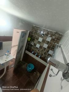 a bathroom with a shower and a toilet and a sink at Kaushlendra Bhawan in Ayodhya