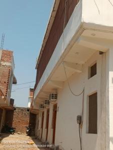 a white building with a brown roof at Kaushlendra Bhawan in Ayodhya