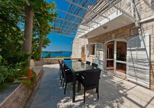 a table and chairs on a patio with a view at Holiday Home Ivanino in Dubrovnik