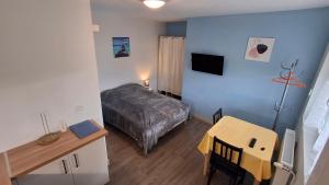 a small room with a bed and a table at Résidence L'IDEALE in La Roche-Posay