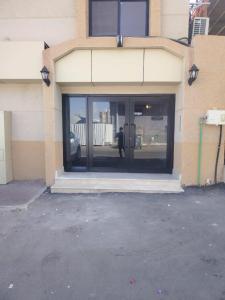 a building with glass doors with a person in it at اورا بلس AURA PALACe in Taif