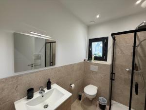 a bathroom with a sink and a toilet and a shower at Le 6 by Montélimar in Montélimar +4 photos