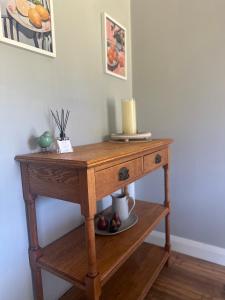 a wooden table with a candle on top of it at Wattle Cottage in Cootamundra