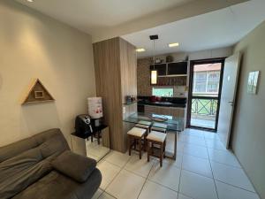 a living room with a couch and a table and a kitchen at Flat com linda vista no Monte Castelo in Sairé +31 photos