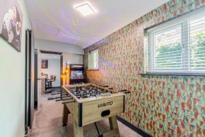 a room with a stove in the middle of a room at Botanic Cottages in Southport