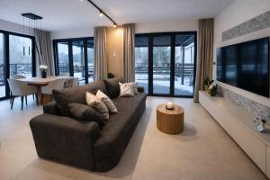 a living room with a couch and a table at Oaza Radęcin in Woldenberg Neumark