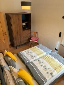 a large bed in a room with a chair at Villa Alessandra in Colle Isarco