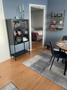 a dining room with a table and a china cabinet at Liten leilighet med to soverom in Valberg