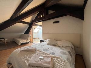 a bedroom with a bed in a attic at Wood & Cosy in Thizy-les-Bourgs