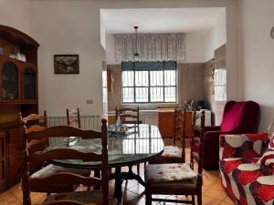 a living room with a glass table and chairs at La Pennichella in Agerola