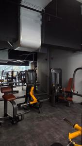 a gym with lots of cardio equipment in a room at Blue Sky Studio with pool and spa in Sinaia