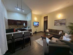 a living room with a couch and a kitchen at Nadyapartment in Dodoma +6 photos