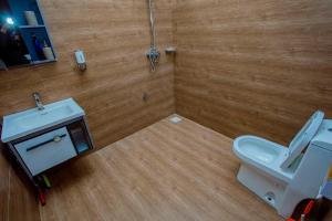 a bathroom with a white toilet and a sink at Nadyapartment in Dodoma