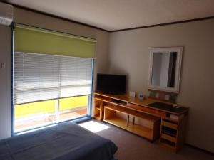 a bedroom with a bed and a desk and a window at SYO Heights 501-3Bed in Osaka