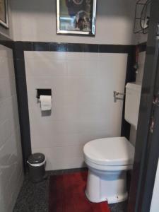 a bathroom with a white toilet and a red rug at Dn Engel le petite in Sittard +13 photos