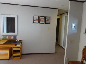 a room with a white wall with three pictures on the wall at SYO Heights 501-3Bed in Osaka