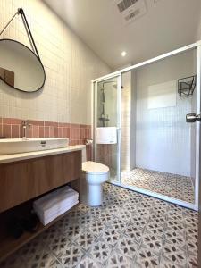 a bathroom with a tub and a toilet and a shower at Yutian B&B in Zhuangwei +5 photos