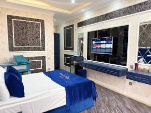 a bedroom with a bed and a flat screen tv at Panorama Resort Oghuz in Oğuz