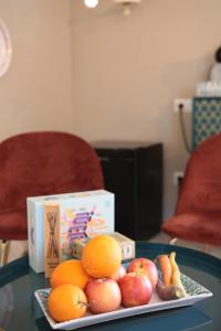 a plate of apples oranges and other fruits on a table at Lo splendore dei Sassi in Matera