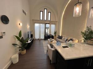 a living room with a couch and a table at 2 Bedroom Villa with Private Pool in Ras al Khaimah