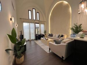 a living room with a couch and a table at 2 Bedroom Villa with Private Pool in Ras al Khaimah +69 photos