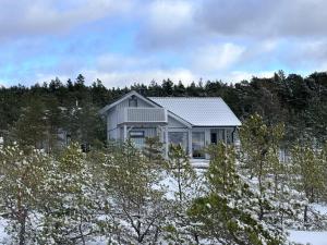 a house on top of a hill with trees at Romantic beach cottage in Kalana