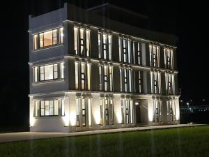 a lit up building with lights on it at night at Yutian B&B in Zhuangwei